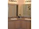 Double vanity bathroom with light wood cabinets and a corner sink at 608 Copeland Dr, Haines City, FL 33844