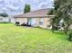 Rear view of a one-story house with patio and backyard at 324 Baccarat Ct, Kissimmee, FL 34759