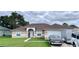 One-story house with a brown roof, tan exterior and a two-car garage at 324 Baccarat Ct, Kissimmee, FL 34759