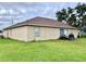 Rear view of a one-story house with patio and backyard at 324 Baccarat Ct, Kissimmee, FL 34759