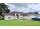 One-story house with a brown roof, tan exterior and a two-car garage at 324 Baccarat Ct, Kissimmee, FL 34759