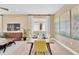 Bright dining area with wood table and yellow chairs, showcasing large artwork at 3896 Deer Ridge Dr, Mount Dora, FL 32757