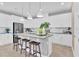 Modern kitchen with white cabinets, gray countertops and island with seating at 3896 Deer Ridge Dr, Mount Dora, FL 32757