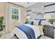 Bright bedroom with a queen-size bed and a stylish accent wall at 3896 Deer Ridge Dr, Mount Dora, FL 32757