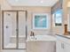 Bathroom featuring a large walk-in shower and soaking tub at 3896 Deer Ridge Dr, Mount Dora, FL 32757