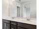 Double vanity bathroom with dark brown cabinets and a large mirror at 3871 Pinewood Gardens, Saint Cloud, FL 34769