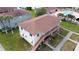 Two-story building with multiple units, stairs, and a partial view of a pool at 725 Michigan Ct # 3, St Cloud, FL 34769