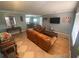 Living room with leather couches and wood floors at 1615 Martinsville Ct, Orlando, FL 32825