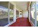 Relaxing screened porch with red flooring and sliding glass doors at 3757 Eagle Isle Cir, Kissimmee, FL 34746