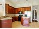 Spacious kitchen with wood cabinets, stainless steel appliances, and an island at 3757 Eagle Isle Cir, Kissimmee, FL 34746