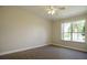Bright bedroom featuring a large window, ceiling fan, and neutral walls at 3757 Eagle Isle Cir, Kissimmee, FL 34746