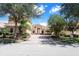 Two-story house with tan exterior, paver driveway, and lush landscaping at 3757 Eagle Isle Cir, Kissimmee, FL 34746