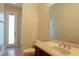 Clean bathroom with single sink vanity, toilet, and exterior access at 3757 Eagle Isle Cir, Kissimmee, FL 34746
