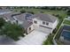 Two-story house with three-car garage and solar panels at 5657 Mangrove Cove Ave, Winter Garden, FL 34787