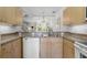 Kitchen with light wood cabinets and a granite countertop at 1256 S Beach Cir, Kissimmee, FL 34746