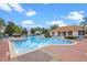 Inviting community pool and clubhouse with lounge chairs at 1256 S Beach Cir, Kissimmee, FL 34746