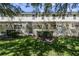 Building exterior showcasing multiple units with private patios and lush landscaping at 1256 S Beach Cir, Kissimmee, FL 34746