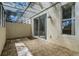 Screened-in patio with tiled floor and sliding glass door access at 1256 S Beach Cir, Kissimmee, FL 34746