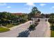 Gated community entrance with lush landscaping and signage at 1256 S Beach Cir, Kissimmee, FL 34746