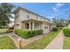 Tan two-story home with attached garage and landscaping at 2078 Cypress Bay Blvd, Kissimmee, FL 34743