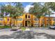 Front view of a yellow apartment building with landscaping and parking at 4524 Commander Dr # 1634, Orlando, FL 32822