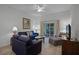 Living room with comfortable seating and access to a screened patio at 306 Lucaya Loop # B5/U306, Davenport, FL 33897