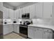 Modern kitchen with stainless steel appliances and white cabinetry at 306 Lucaya Loop # B5/U306, Davenport, FL 33897