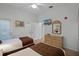 Bedroom with two twin beds, dresser, and access to bathroom at 306 Lucaya Loop # B5/U306, Davenport, FL 33897
