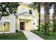 Charming yellow two-story building with lush landscaping and welcoming entrance at 306 Lucaya Loop # B5/U306, Davenport, FL 33897