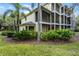 Two-story building with screened porches and lush landscaping at 306 Lucaya Loop # B5/U306, Davenport, FL 33897