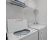 Laundry room with washer, dryer, and overhead shelving at 306 Lucaya Loop # B5/U306, Davenport, FL 33897