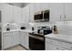 Modern kitchen with stainless steel appliances and white cabinetry at 306 Lucaya Loop # B5/U306, Davenport, FL 33897