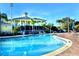 Resort-style pool with clubhouse and palm trees at 306 Lucaya Loop # B5/U306, Davenport, FL 33897