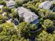 Aerial view of a residential building nestled in a wooded area at 306 Lucaya Loop # B5/U306, Davenport, FL 33897