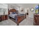 King bedroom with dark wood furniture and en-suite bathroom at 7535 Oakmoss Loop, Davenport, FL 33837