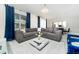 Spacious living area with sectional sofa, large windows and modern decor at 1676 Moon Valley Dr, Davenport, FL 33896