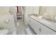 Shared bathroom with double vanity and a view of a bedroom at 1676 Moon Valley Dr, Davenport, FL 33896