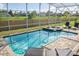 Inviting screened pool area with spa and lounge chairs; enjoy the Florida sunshine! at 1676 Moon Valley Dr, Davenport, FL 33896