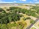 Aerial view showing home, pond, and surrounding landscape at 4350 E Hinson Ave, Haines City, FL 33844