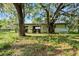 Detached workshop with storage space under large trees at 4350 E Hinson Ave, Haines City, FL 33844