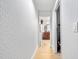 Hallway with light walls and wood floors leading to bathroom at 4350 E Hinson Ave, Haines City, FL 33844