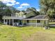 Yellow house with large deck and screened porch at 4350 E Hinson Ave, Haines City, FL 33844