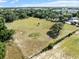 Aerial view of large lot with surrounding trees and fence at 4350 E Hinson Ave, Haines City, FL 33844