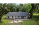 Newly constructed home with a white exterior, gray roof, and a spacious yard at 424 Wilder Rd, Lakeland, FL 33809