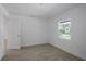 Simple bedroom with a window, tile floor, and neutral decor at 424 Wilder Rd, Lakeland, FL 33809
