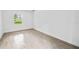 Bright bedroom with neutral walls, wood-look tile floor, and window at 424 Wilder Rd, Lakeland, FL 33809