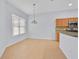 Kitchen dining area with tile flooring and a light fixture at 5421 Los Palma Vista Dr, Orlando, FL 32837