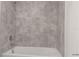 Bathroom featuring a shower/tub combo and grey tile at 1928 Rock Maple Bnd, Kissimmee, FL 34746