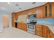 Kitchen with wood cabinets, stainless steel appliances, and light blue walls at 912 Avenue T Se, Winter Haven, FL 33880