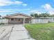 Single story house with carport and a large front yard at 912 Avenue T Se, Winter Haven, FL 33880